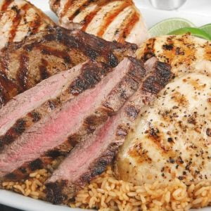 Assorted Hispanic Meats on Bed of Rice on White Tray Food Picture