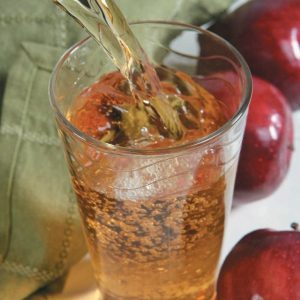 Pouring a Glass of Apple Juice with Apples Food Picture
