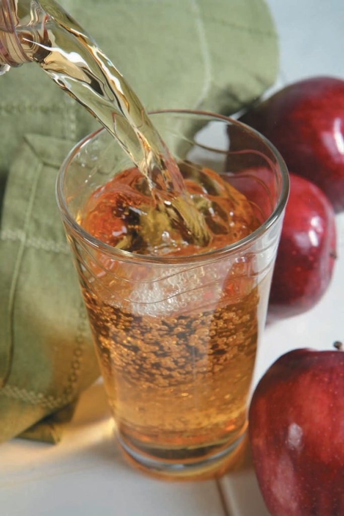 Pouring a Glass of Apple Juice with Apples Food Picture