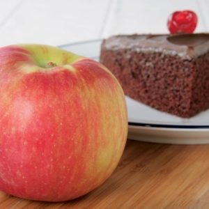An Apple Next to a Cake on a Plate Food Picture