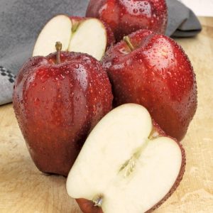 Whole and Halved Washed Red Delicious Apples on Board Food Picture