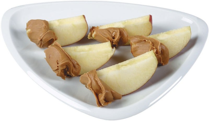 Apple Slices on a Plate Dipped in Peanut Butter Food Picture
