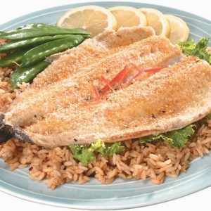 Baked Trout Over Rice on a Plate with Whole Peas and Lemon Slices Food Picture