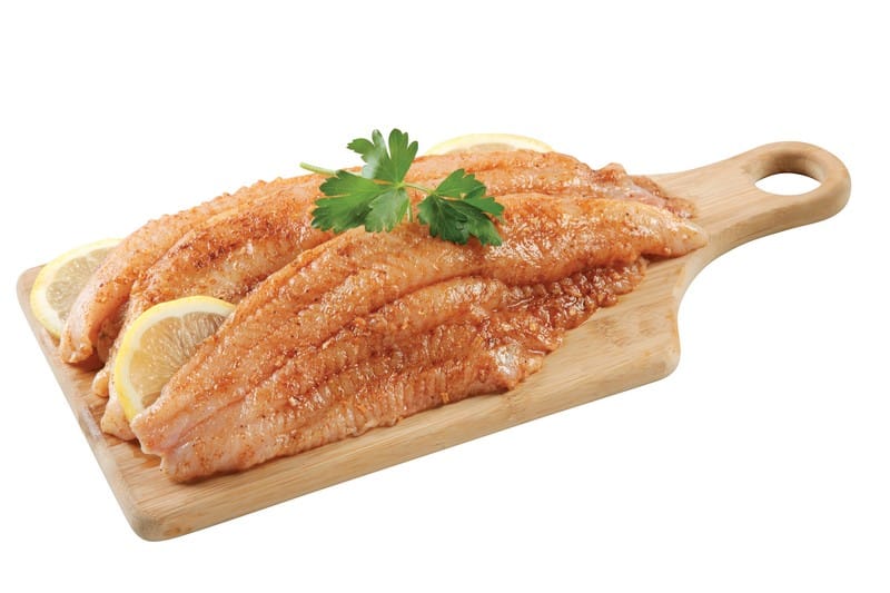 Basa Fillets on a Board with Lemon Slices Food Picture