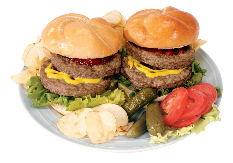Two Double Hamburgers with Chips, Pickles and Tomatoes Food Picture