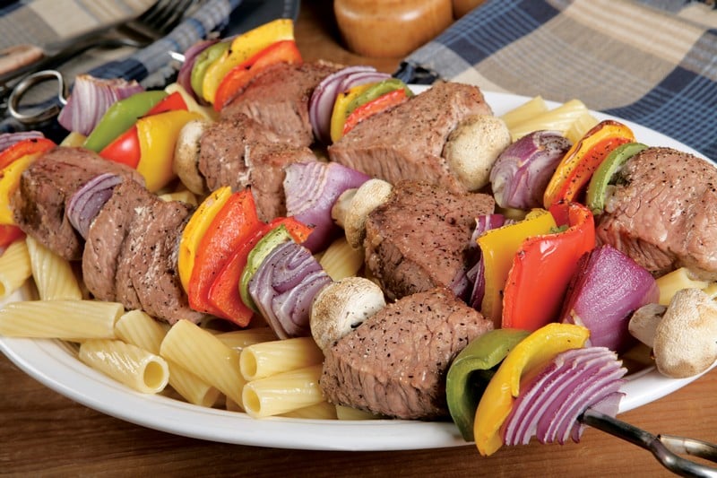 Cooked Beef Kabobs over Pasta Food Picture