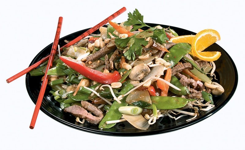 Orange Beef Stir Fry on Black Plate with Red Chopsticks Food Picture