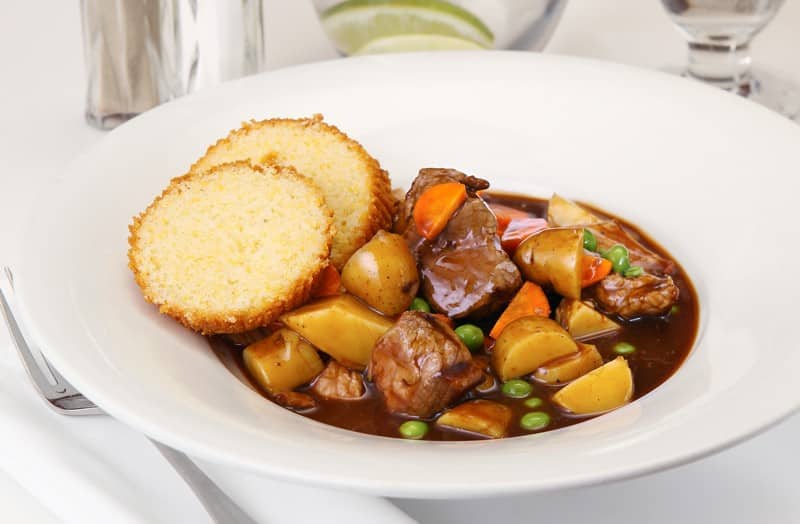 Hearty Rustic Beef Stew in Bowl with Bread for Dipping Food Picture