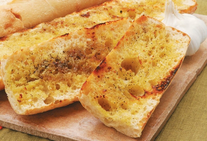 Crispy Grilled Garlic Bread on Cutting Board Food Picture