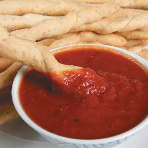 Dipping Breadsticks in Sauce Food Picture