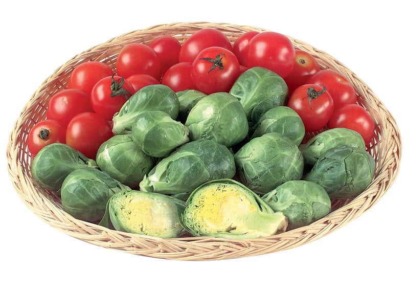 Brussels sprouts with tomatoes in wicker basket on white background Food Picture