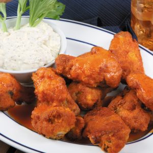 Buffalo Wings on White Plate with Blue Trim Food Picture