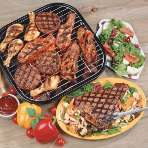 Assorted Meats on Small Grill surrounded by Fresh Ingredients and Salad on Wooden Background Food Picture