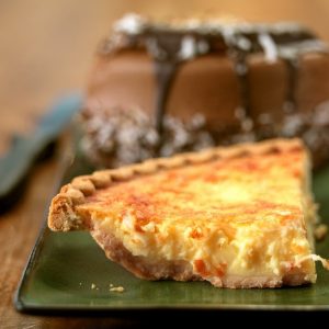 Whole Chocolate Fudge Cake and Slice of Custard Pie Food Picture