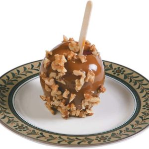 A Caramel Apple with Nuts in a Plate Food Picture