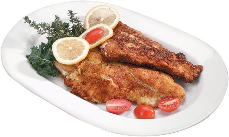 Cooked Catfish on a Plate with Tomatoes and Lemon Slices Food Picture