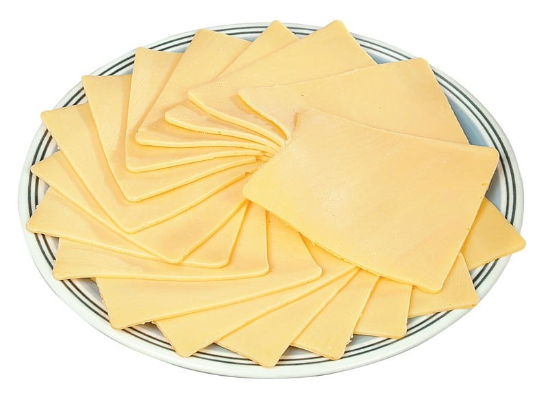 Sliced Yellow American Cheese on Striped Plate Food Picture