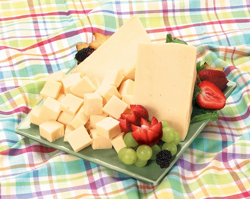 Cheddar Cheese with Fruit Garnish on Green Plate Food Picture