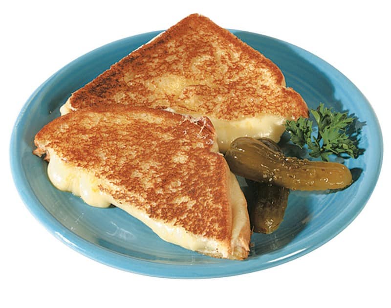 Grilled Cheese Sandwich with Pickle and Garnish on Blue Plate Food Picture