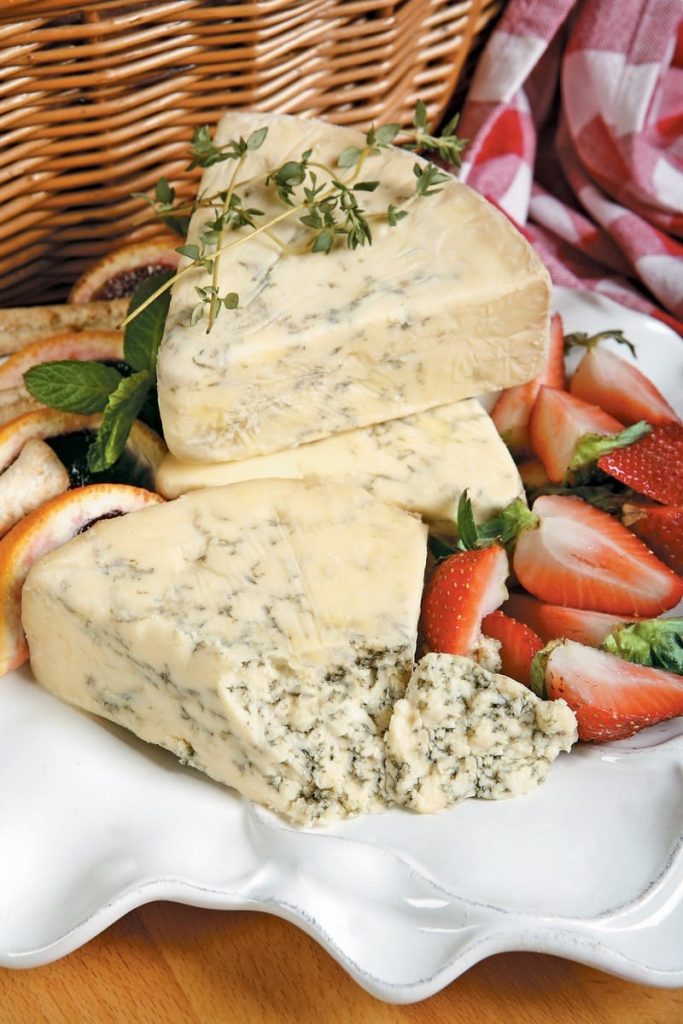 Stilton English Cheese with Garnish and Strawberries on White Dish Food Picture