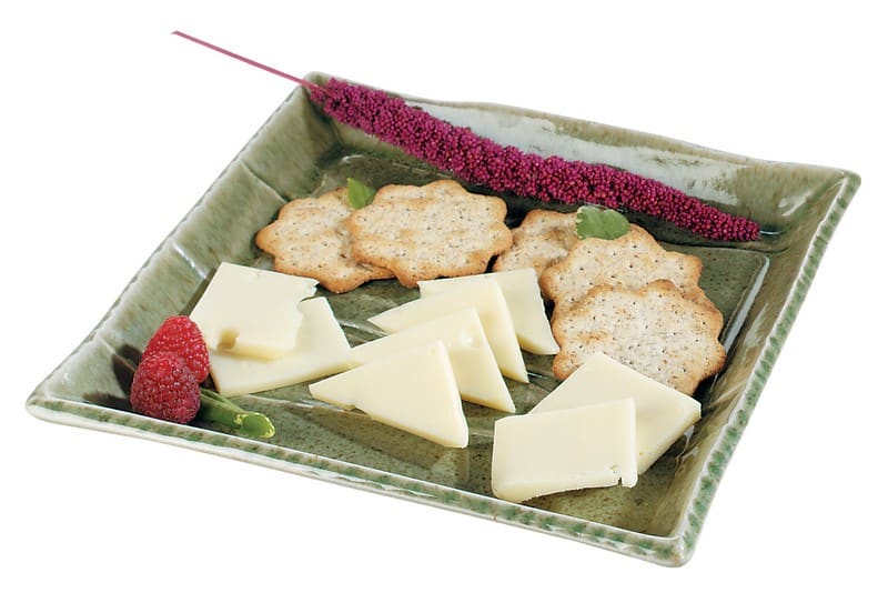 Swiss Cheese with Crackers and Garnish on Green Plate Food Picture
