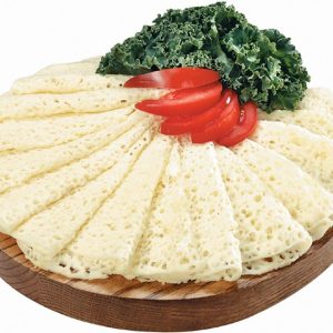 Thin Sliced Swiss Cheese with Garnish on Wooden Board Food Picture