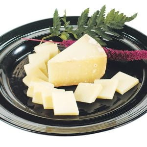Tome Agour Cheese with Garnish on Black Plate Food Picture