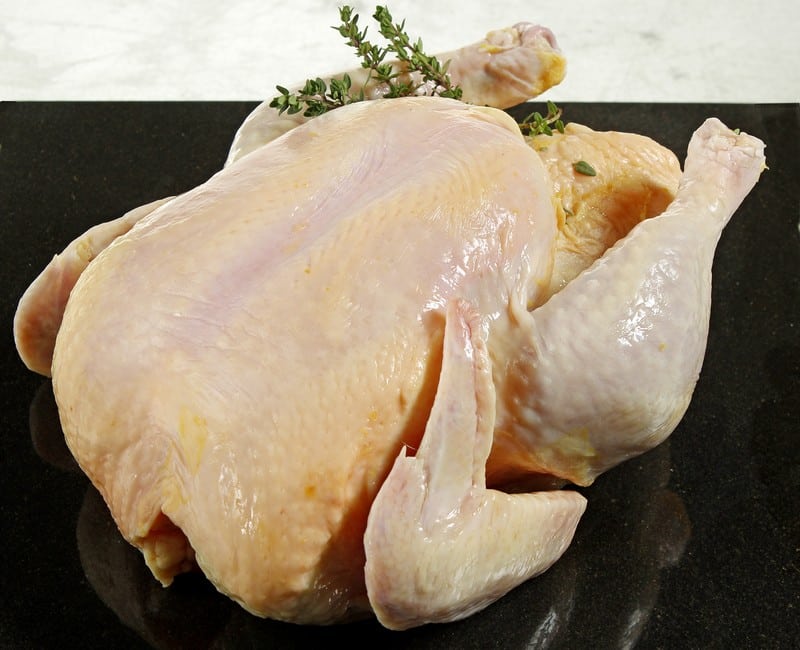 Whole Raw Roasting Chicken with Garnish Food Picture