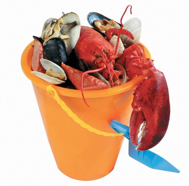 Clambake in orange pail with yellow handle and blue shovel Food Picture