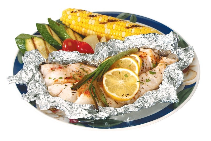 Cod Fillet in Foil with Corn and Lemon on Plate Food Picture