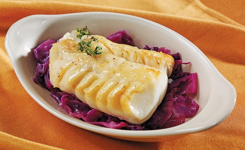 Cod Fillet with Garnish in White Dish on Orange Cloth Food Picture