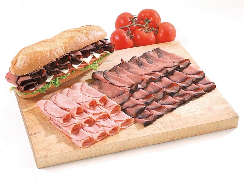 Cold Cut Assortment on Wooden Board with Tomatoes on Side Food Picture
