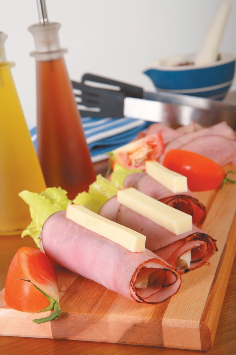 Cold Cut Assorted Roll Ups with Garnish on Wooden Surface Food Picture