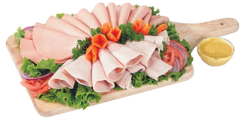 Cold Cut Assortment on Wooden Board with Garnish and Mustard Food Picture