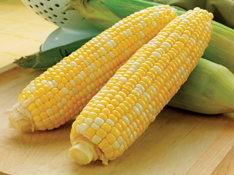 Ears of corn on wooden surface Food Picture