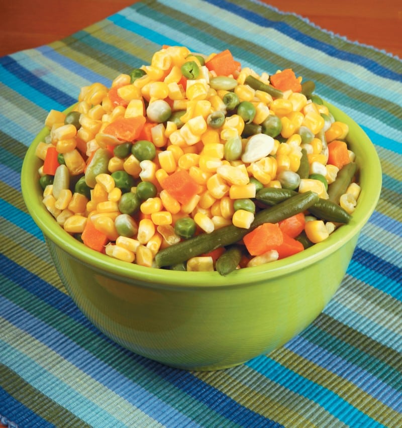 Corn, peas, carrots, and green bean assortment on blue toned placemat Food Picture