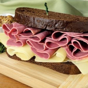 Corned Beef Sandwich with Garnish on Wooden Surface Food Picture