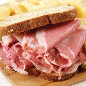 Corned Beef Sandwich with Chips on Wooden Surface Food Picture