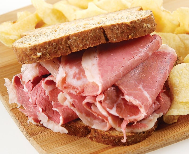 Corned Beef Sandwich with Chips on Wooden Surface Food Picture