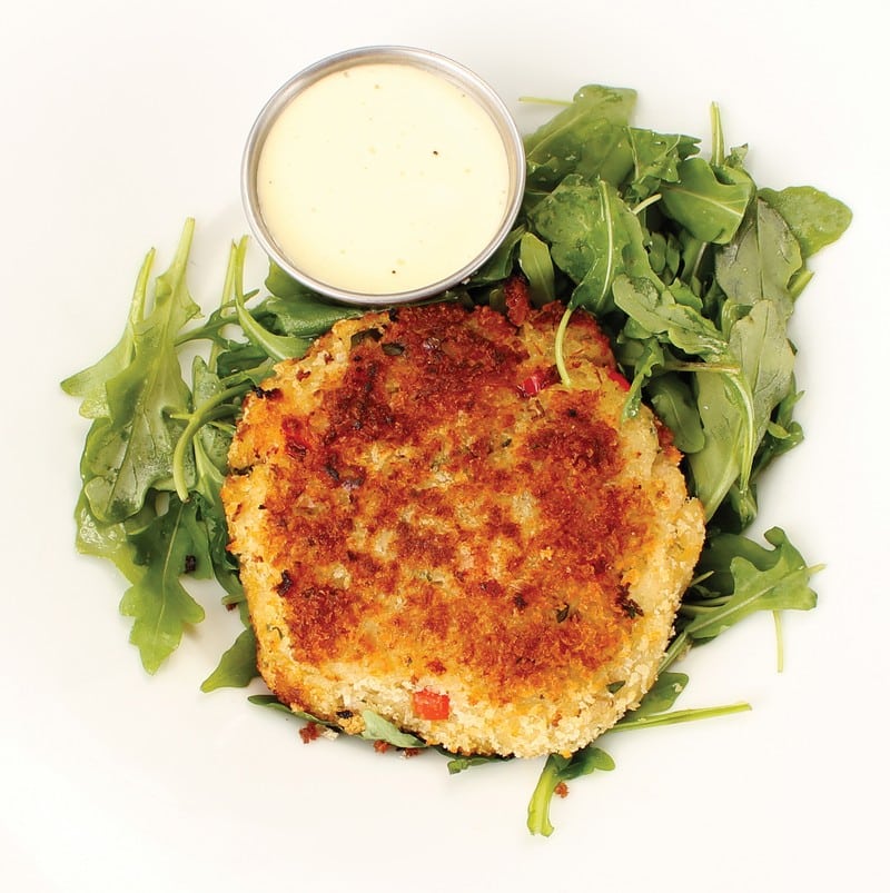 Crab Cake over Greens with Sauce on White Background Food Picture