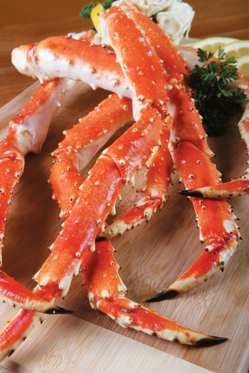 Crab Legs on Wooden Surface with Garnish Food Picture