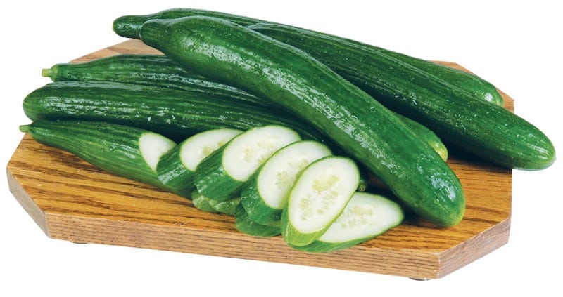 Whole and Sliced Seedless Cucumbers on Board Food Picture