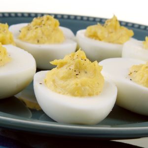 Deviled Eggs with Sprinkled Pepper on Blue Plate Food Picture