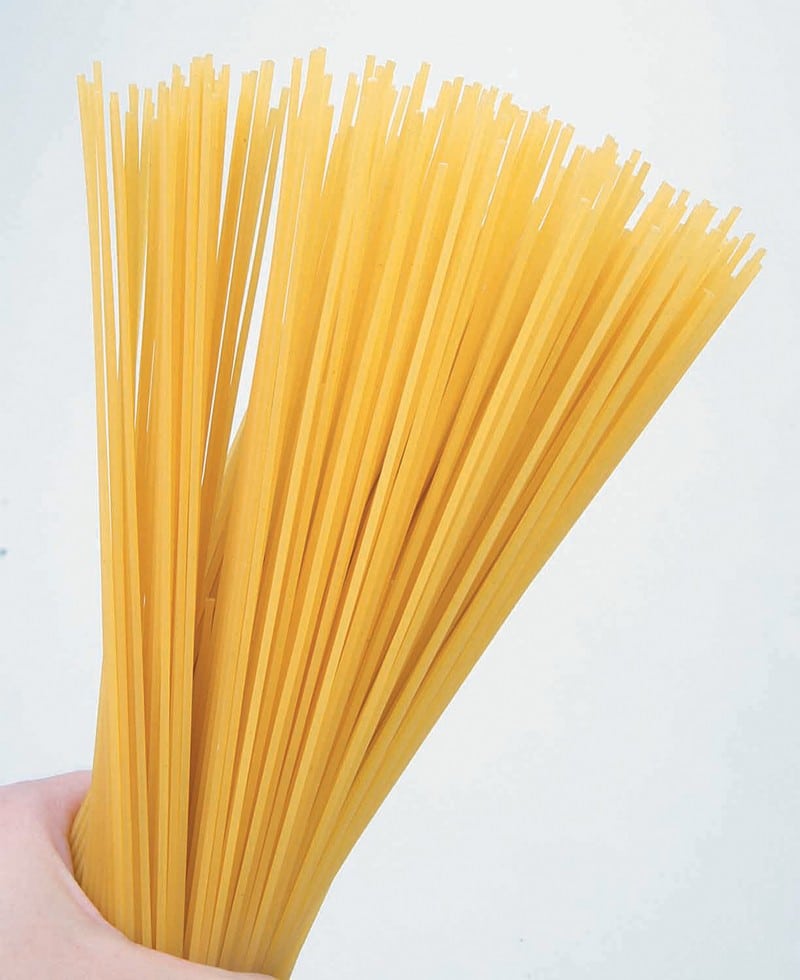 Person Holding Dried Spagetti Food Picture
