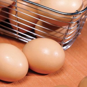 Brown Eggs in and around Wire Basket Food Picture