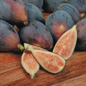 Whole and Quartered Figs on Wooden Surface Food Picture