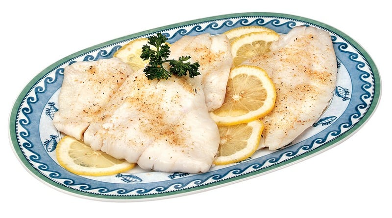 Flounder Fillet over Lemon with Garnish Food Picture