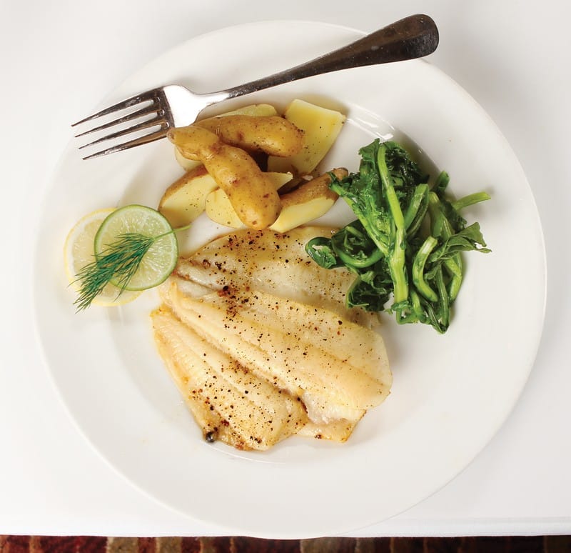 Flounder Fillet with Veggies and Potatoes on White Plate with Fork Food Picture
