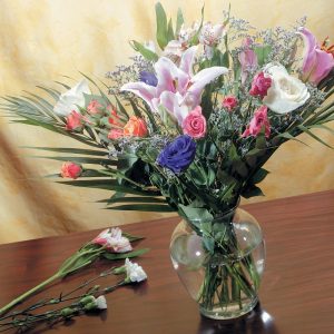 Flower Arrangnments in a Vase on a Tabe Food Picture