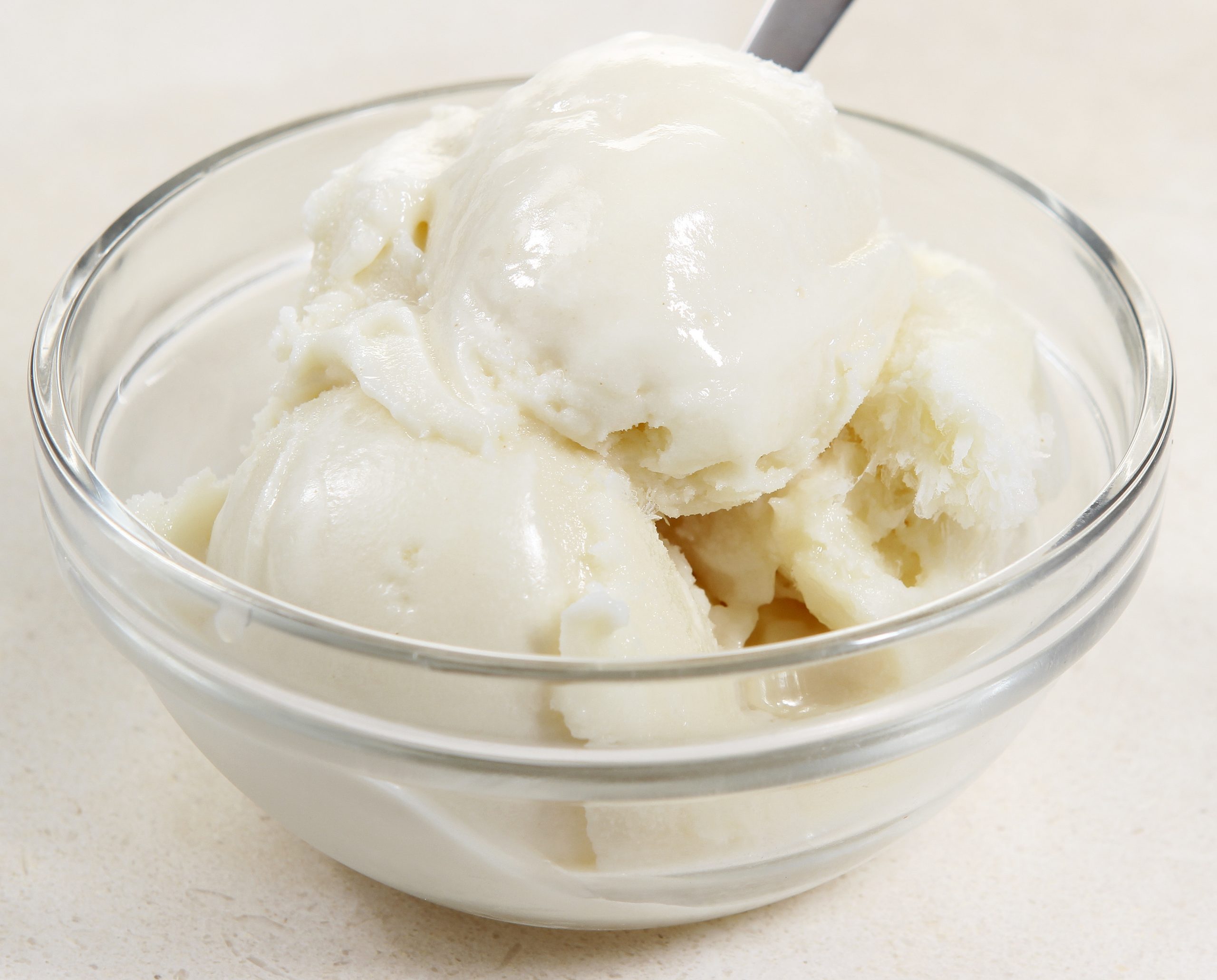 Vanilla Frozen Custard Yogurt Ice Cream in White Glass Bowl on Sand Formica Countertop Food Picture